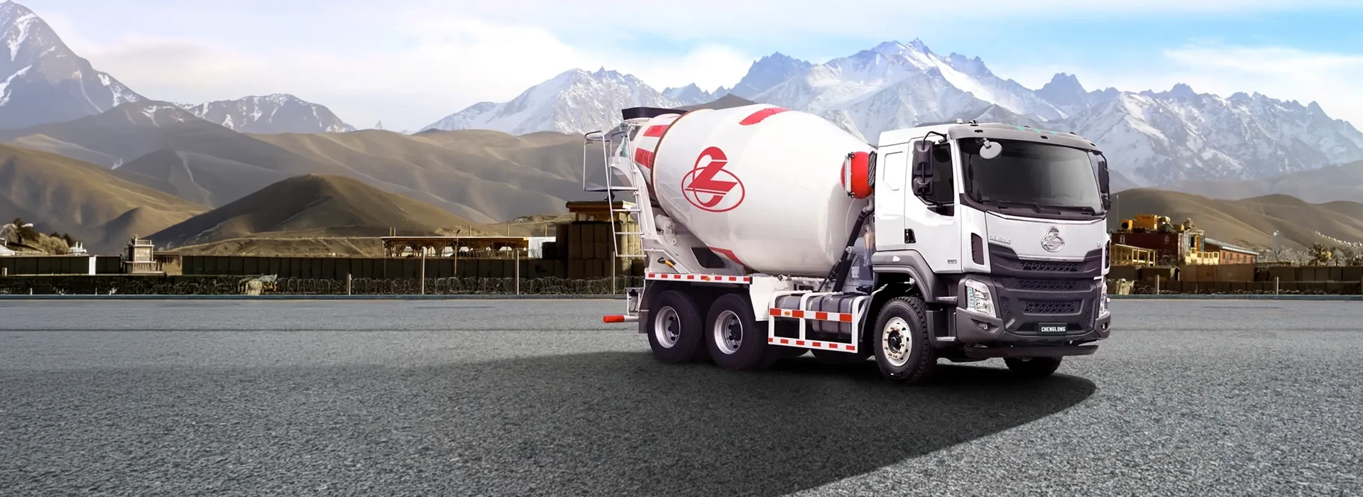 White Chenglong H5 Mixer mixer truck on asphalt with mountain background