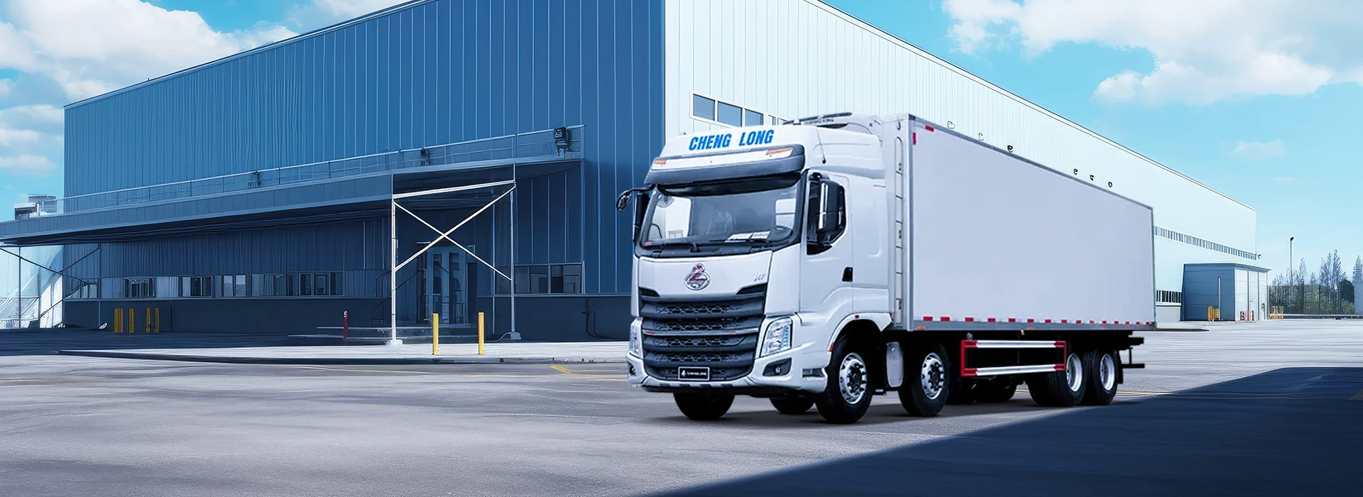 White Chenglong H7 refrigerated cargo truck parked outside a modern blue and white logistics warehouse.