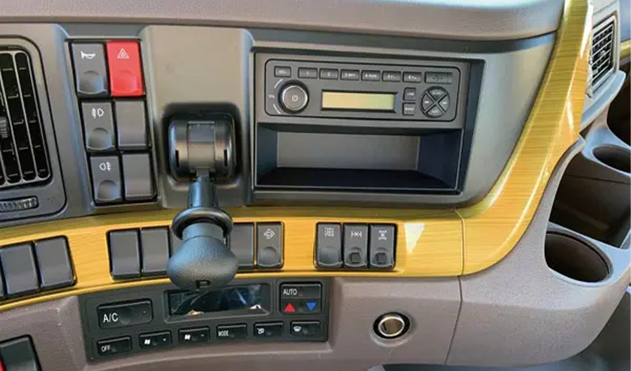 Chenglong Heavy-duty truck dashboard centre console showing gear selector, radio, climate controls and function switches