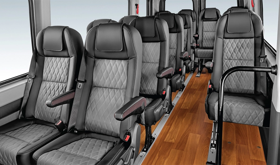 Spacious interior cabin of Force Motors Urbania featuring diamond-quilted reclining seats and wood-finish flooring