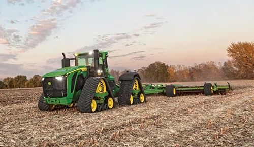 John Deere 9RX Series quad track agricultural tractor working in field
