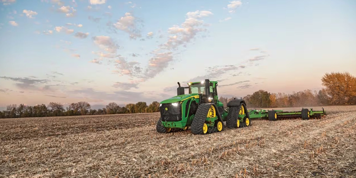 John Deere 9RX Series quad track agricultural tractor working in field