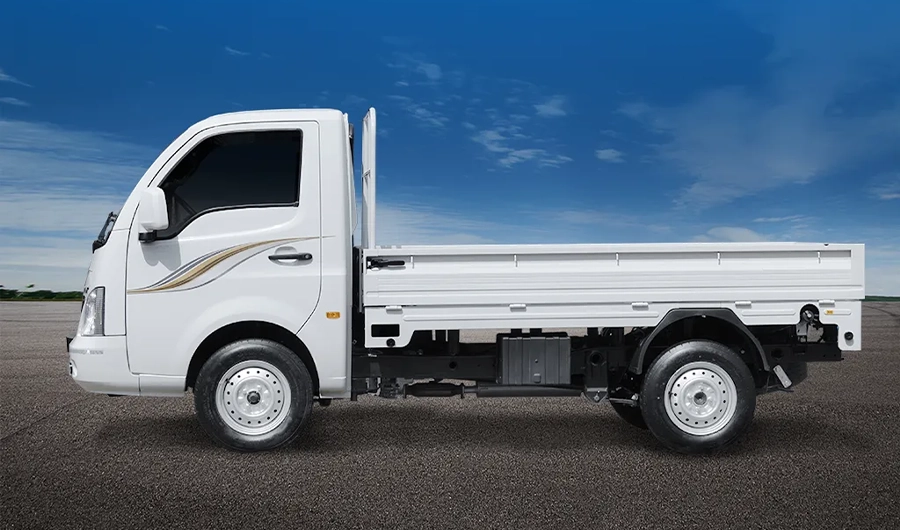 White Tata Super Ace mini truck shown in side profile on a paved road under a blue sky.