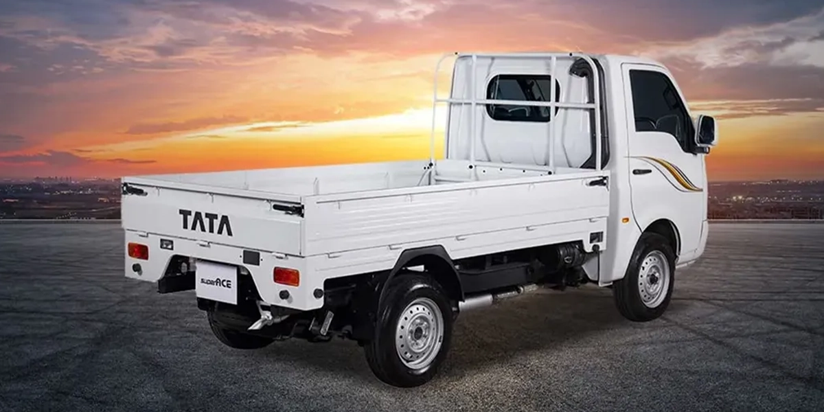 White Tata Super Ace light commercial pickup truck parked against a sunset background