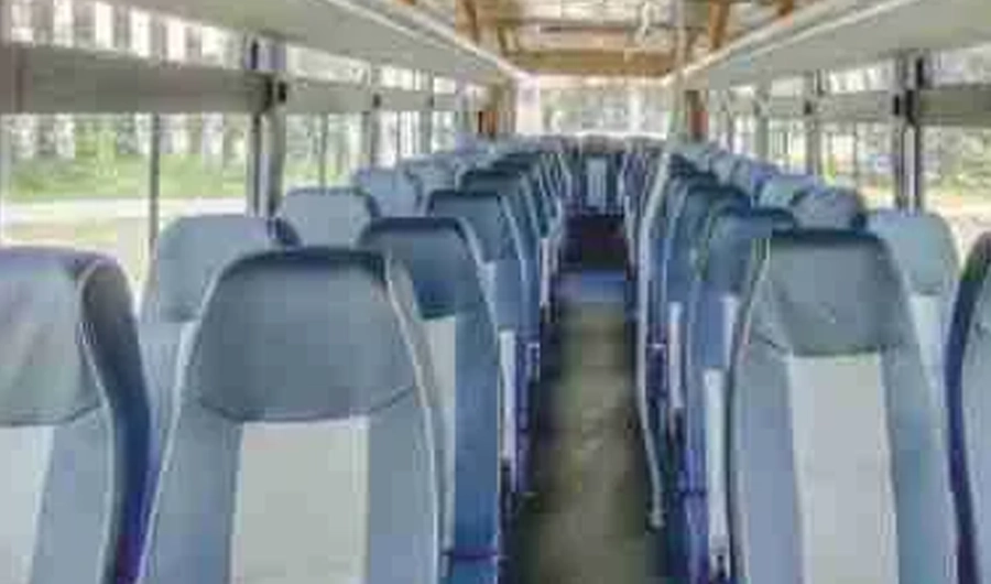 Commercial bus interior showing rows of passenger seats and central aisle