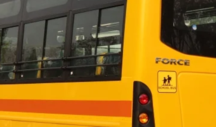 Yellow Force Monobus school bus exterior showing passenger windows, safety markings and rear lights
