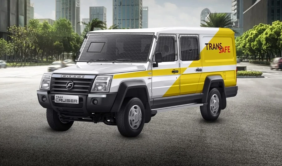 hite and yellow Force Trax Cruiser Transafe cash-in-transit security van equipped with protective window mesh screens parked on a city street