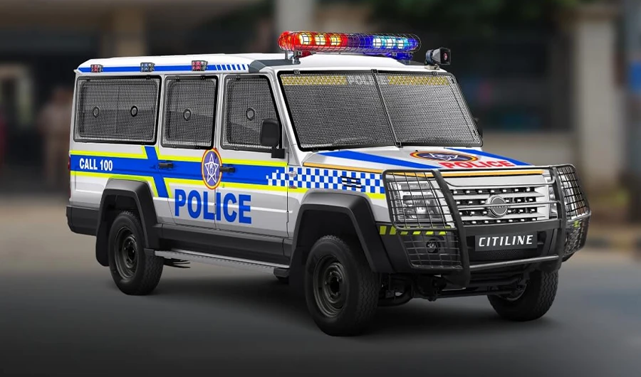 Force Trax Citiline police response vehicle featuring blue and yellow police livery, a roof lightbar siren, front bull bar, and full wire mesh window guards
