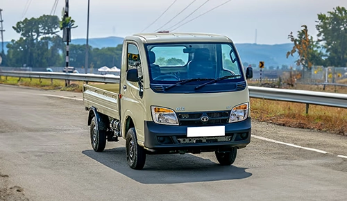 Beige Tata Ace mini truck driving on a highway road