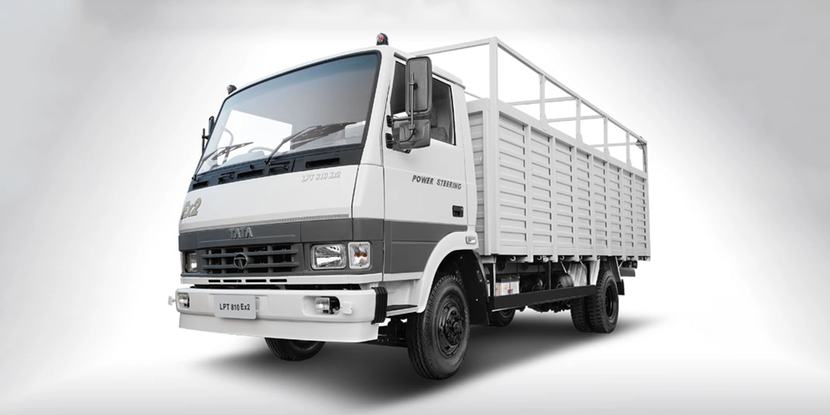 White Tata LPT 810 EX2 light commercial truck featuring a drop-side lattice body, power steering, and dual rear wheels, presented in a studio shot.