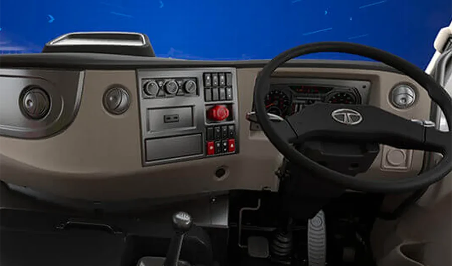 Interior dashboard, steering wheel, and cabin controls of a Tata Signa truck.