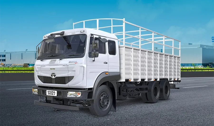 White Tata Signa 2518.T cargo truck with a drop-side body and overhead frame parked on a paved surface.