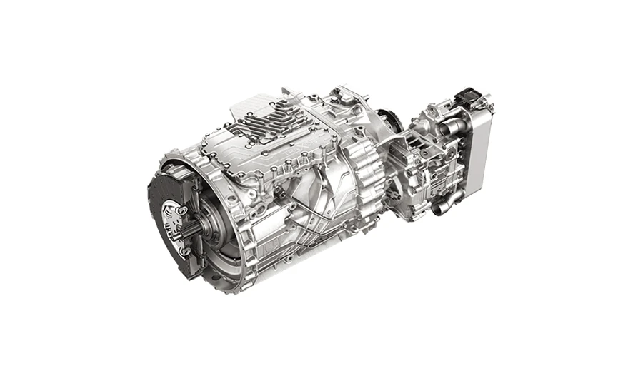 Isolated studio view of a silver ZF TraXon automated manual transmission (AMT) unit with heat exchanger on a white background.