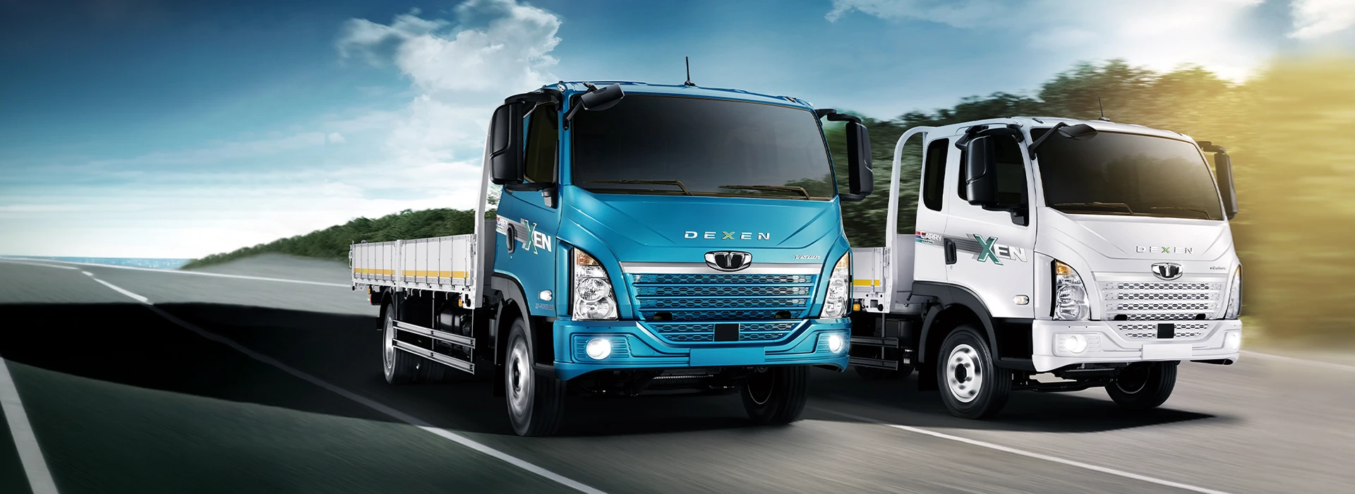 Teal blue and white Daewoo Dexen flatbed trucks driving along an open highway