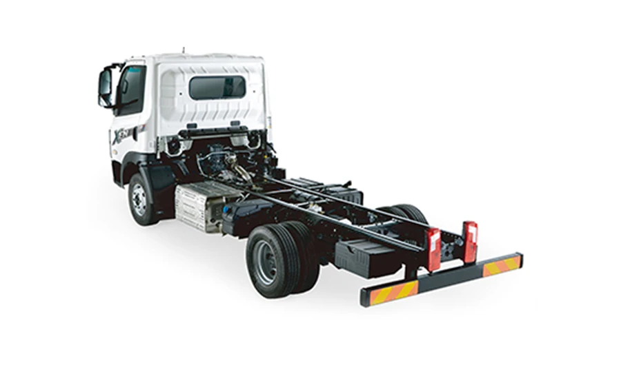 Rear perspective view of a white Daewoo Dexen bare chassis cab truck showing the frame and rear axle