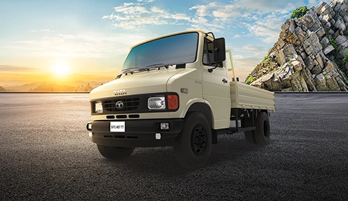 Cream-colored Tata SFC 407 TT light commercial truck with drop-side body