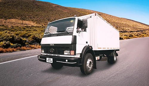 White Tata LPT 1618 closed container truck on a road against mountains desktop banner