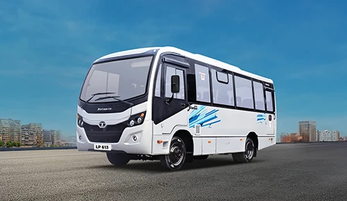 White Tata LP 613 Marcopolo Starbus passenger bus parked on an asphalt road with city background