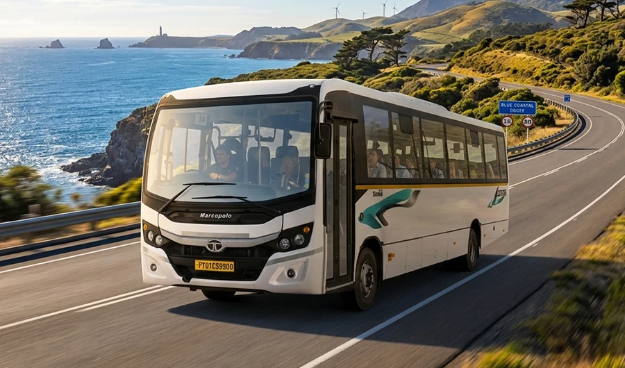 White Tata Starbus Ultra LPO 10.2/54 bus driving along a scenic coastal highway