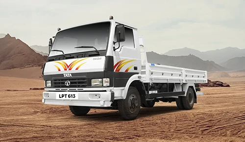 White Tata LPT 613 drop-side flatbed light commercial truck in a desert landscape