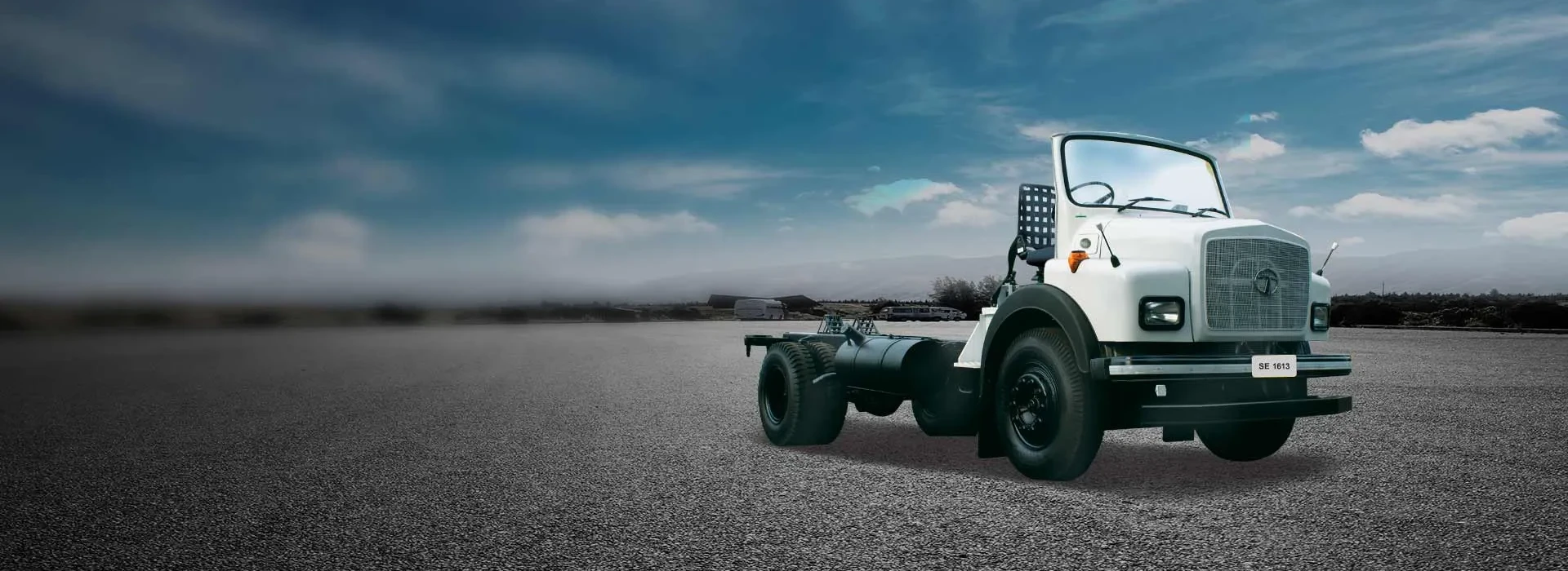 White Tata SE 1613 open cowl truck chassis parked on asphalt background