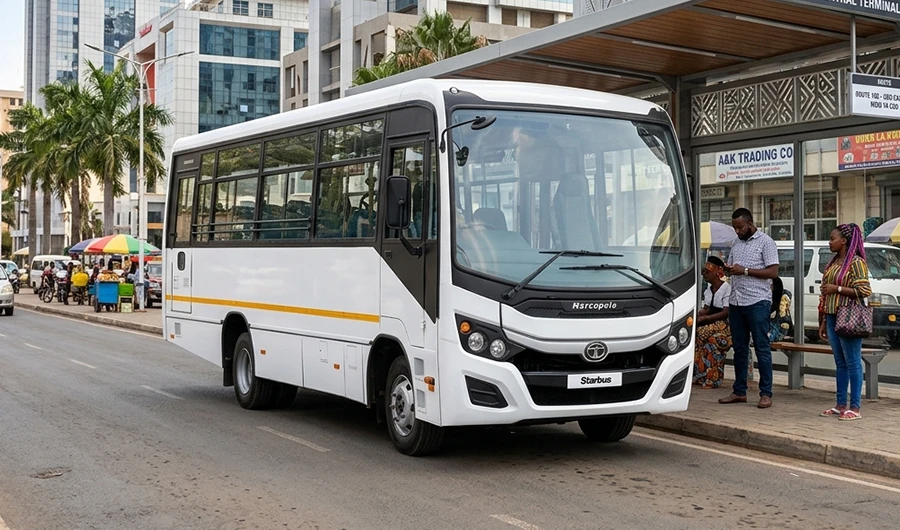 White Tata Starbus Marcopolo commercial passenger bus at a city transit terminal with modern high-rise buildings in the background.