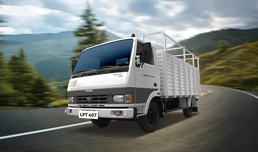 Tata LPT 407 light commercial truck driving on a curved mountain road