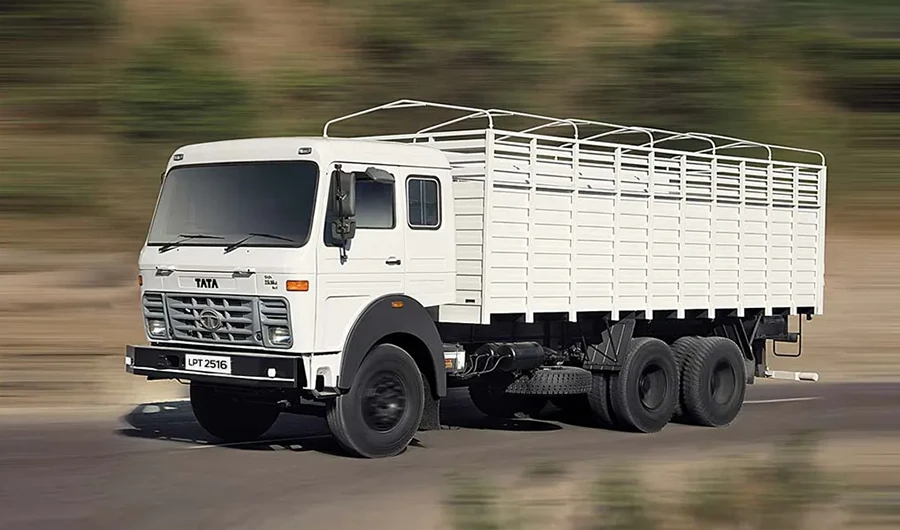 White Tata LPT 2516 multi-axle cargo truck driving on an open road