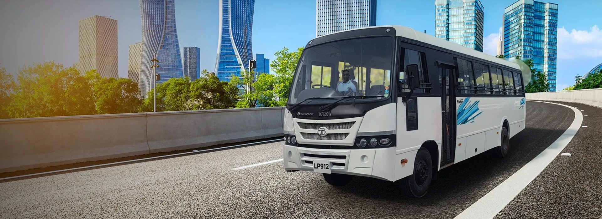 White Tata LP 912 passenger bus driving on a curved highway with modern city skyscrapers in the background