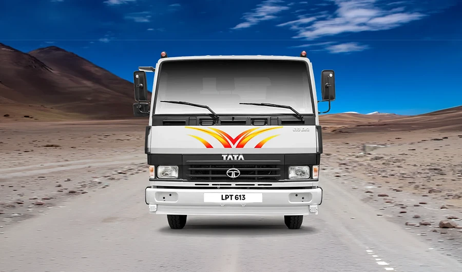White Tata LPT 613 drop-side flatbed light commercial truck in a desert landscape