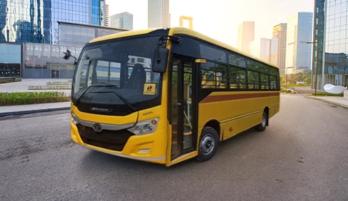 Yellow Tata Starbus Ultra School LPO 8.6/44 bus parked outside a modern commercial building