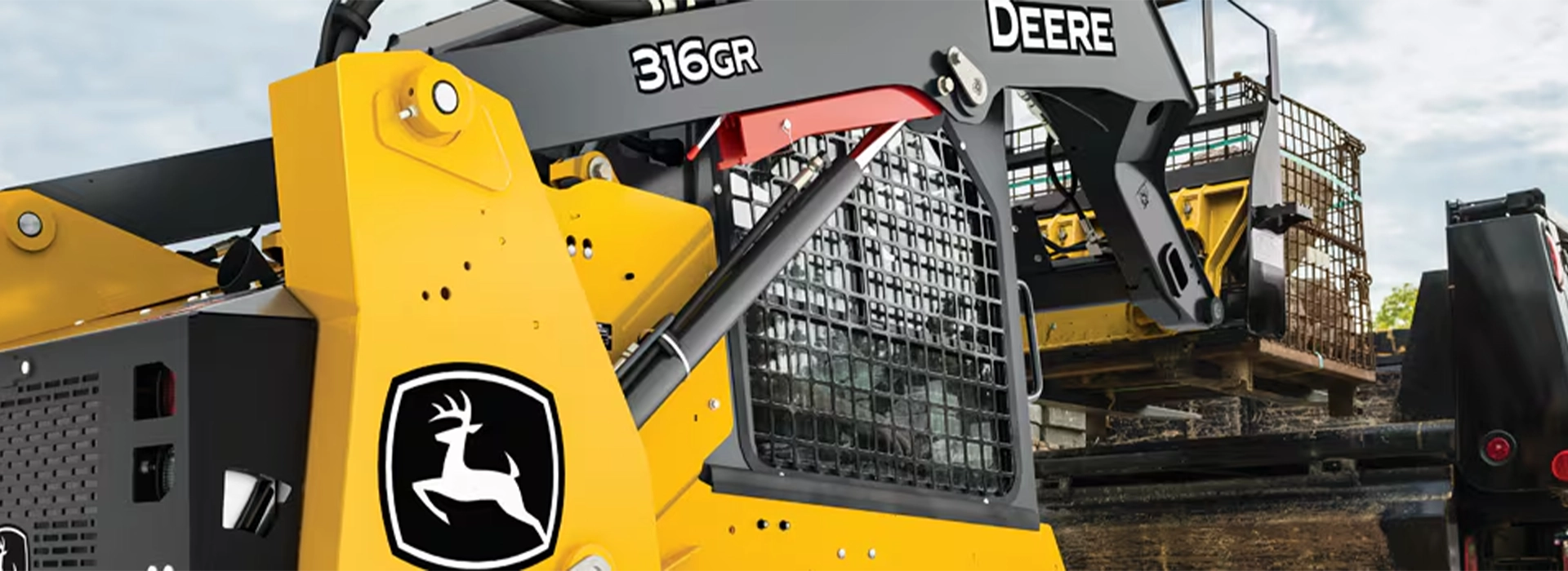 John Deere skid steer loader with front bucket for construction and material handling