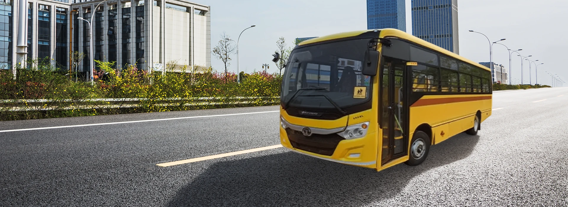 Yellow Tata Starbus Ultra School LPO 8.6/44 bus parked outside a modern commercial building