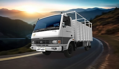 Tata LPT 407 light commercial truck driving around a scenic mountain pass curve