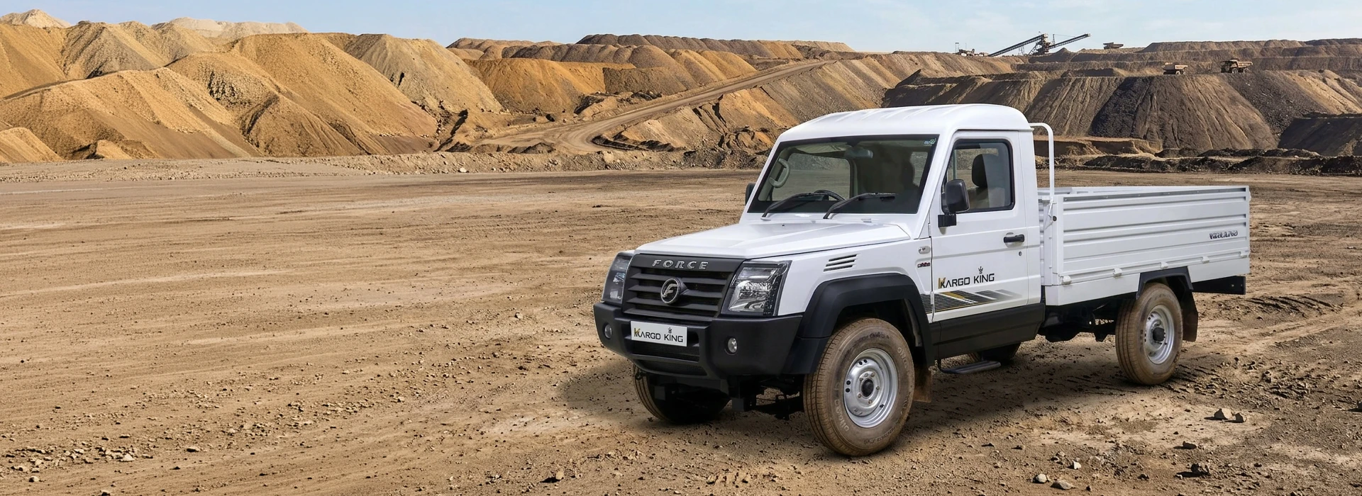 White Force Kargo King single-cab utility pickup truck in a heavy-duty mining quarry with terraced excavations.