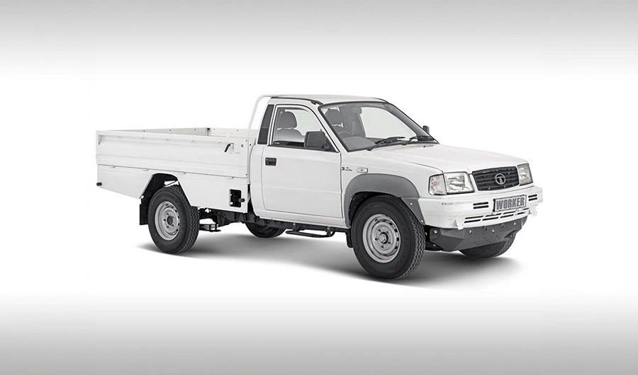 White Tata 207 DI single-cab pickup truck with a long drop-side cargo bed shown against a light gradient background