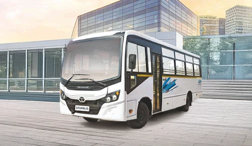 White Tata LPO 1316 54 CNG Starbus parked outside a modern commercial building