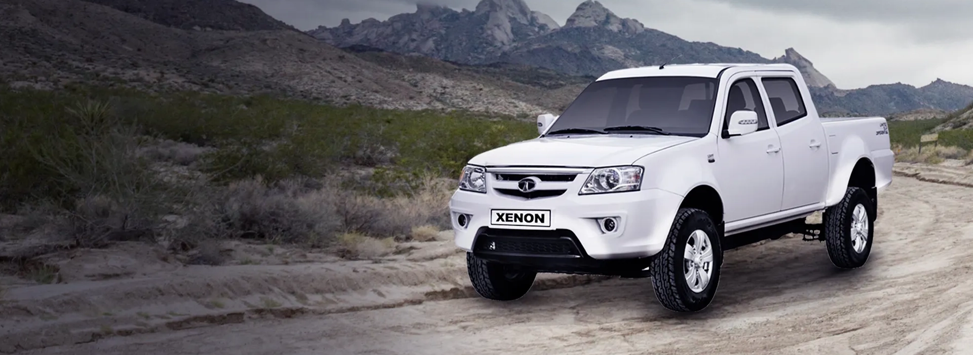 White Tata Xenon double cab pickup truck driving off-road