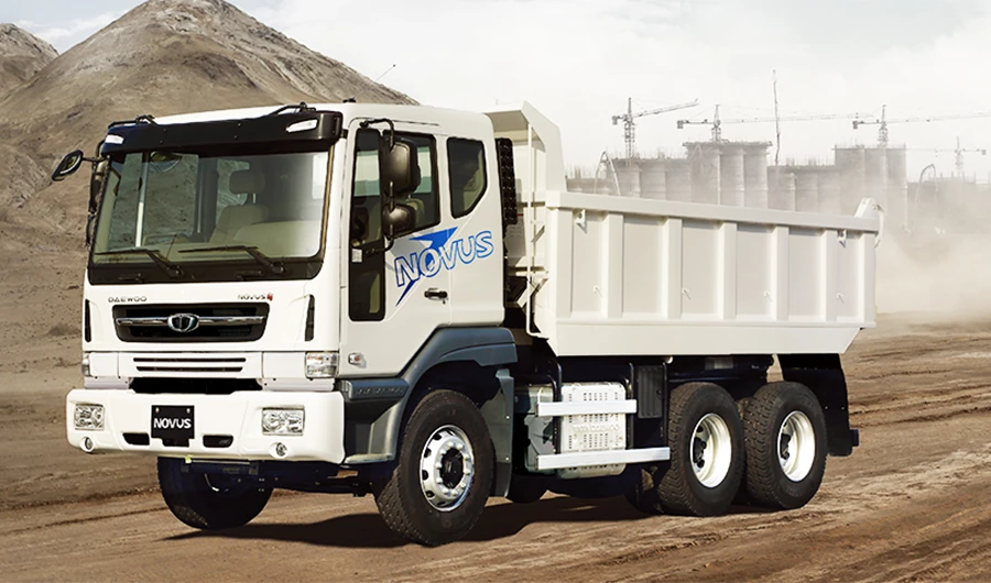 White Daewoo Novus tipper dump truck parked on a dusty construction site