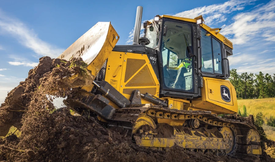 John Deree Dozer exterior pushing a pile of dirt in an open area.